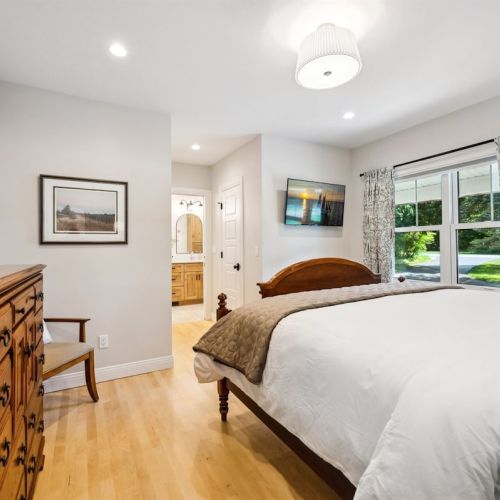 The primary bedroom suite is conveniently on the first floor, and has a King-size bed and an ensuite bath.