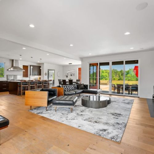 A spacious, modern open-concept living area brings everyone together, while a glowing fireplace and Smart TV create the perfect backdrop for relaxation and entertainment.