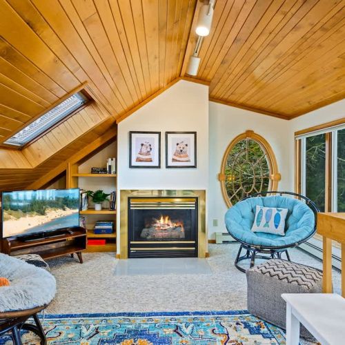 A gas fireplace adds a touch of warmth to this cozy nook, creating the perfect ambiance for delving into the diverse collection of books.