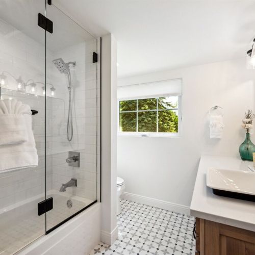 The second-floor Queen suite has an ensuite bath with a single vanity and a tub/shower combination.