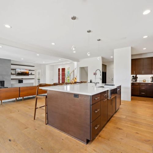 The expansive island provides additional seating and serves as the perfect centerpiece for cooking, entertaining, and connecting.