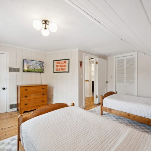 The second bedroom features two twin-sized single beds and smart tv-perfect for kids, teens, and those young at heart.