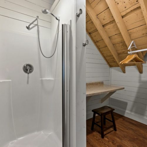 The upstairs features a half bath, as well as a separate shower stall and vanity.