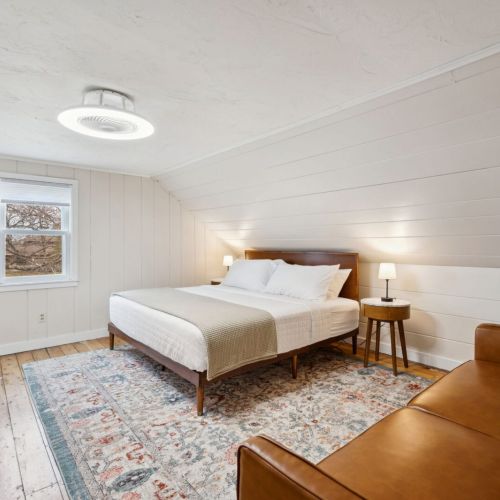 The third and final bedroom, located on the second floor of the home also features a comfortable king-sized bed and smart tv.