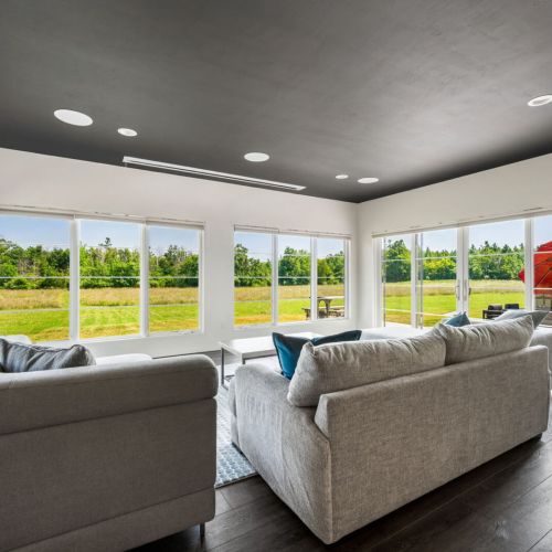 From the dining space, step into the dedicated entertaining wing—complete with a half bath, intimate movie theater with bar, and panoramic views of the prairie landscape.