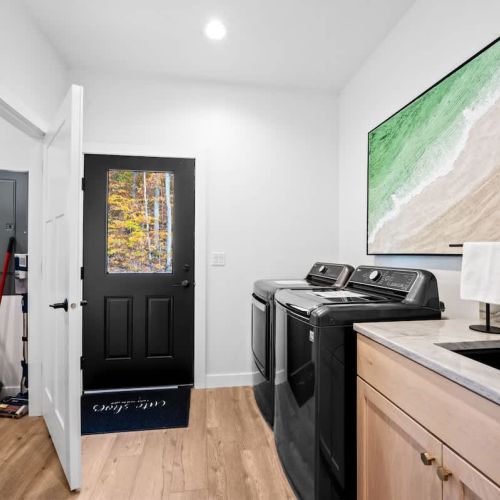 The dedicated laundry area adds convenience and comfort, allowing guests to easily refresh their belongings throughout their stay.