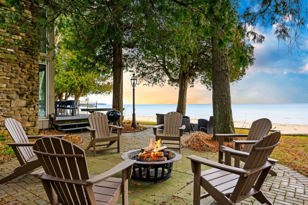 Gather around the crackling embrace of the fire pit at Sandvik House, perfectly positioned to accentuate the natural splendor of Lake Michigan's shoreline. Encircled by Adirondack chairs, this cozy outdoor feature invites guests to enjoy balmy evenings under the stars, share stories, or simply relax to the rhythmic sounds of the waves. It's an idyllic end to any day spent exploring Door County, offering warmth and camaraderie in a picturesque lakeside setting.