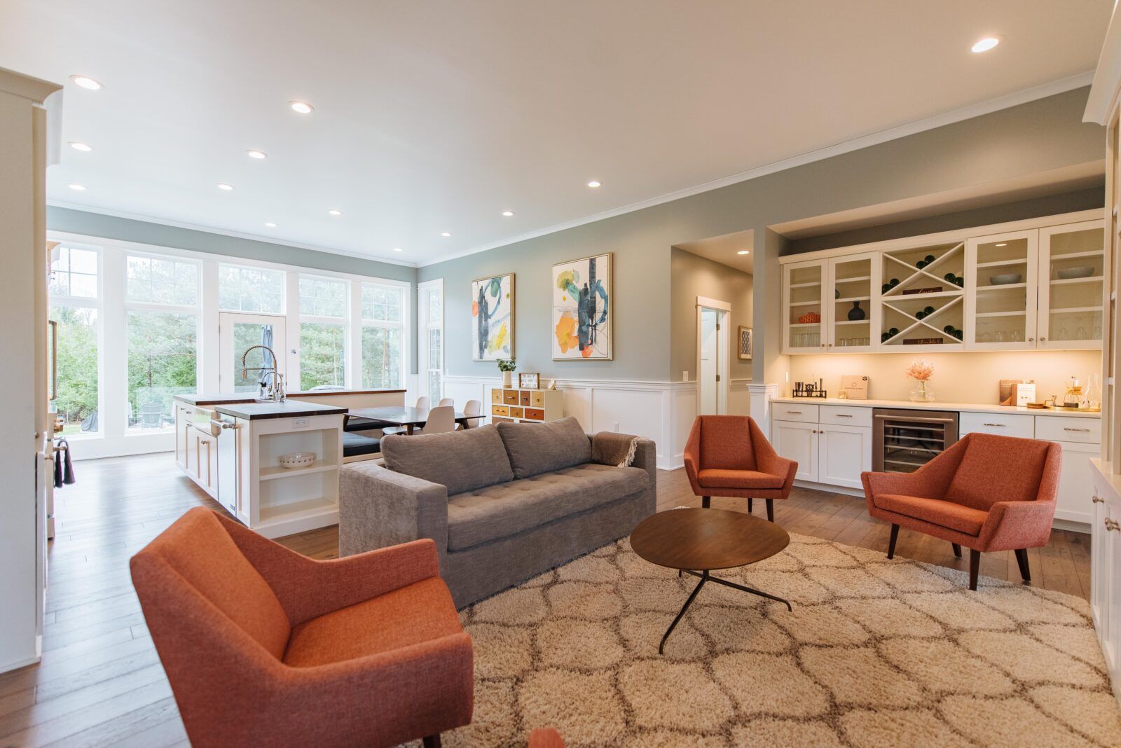 Unwind in Style: Spacious living area with contemporary flair, featuring plush seating and large windows that frame the serene Door County landscape. Perfect for family gatherings or a quiet retreat, this space invites you to relax and savor the comfort of our beautifully designed home in Egg Harbor.